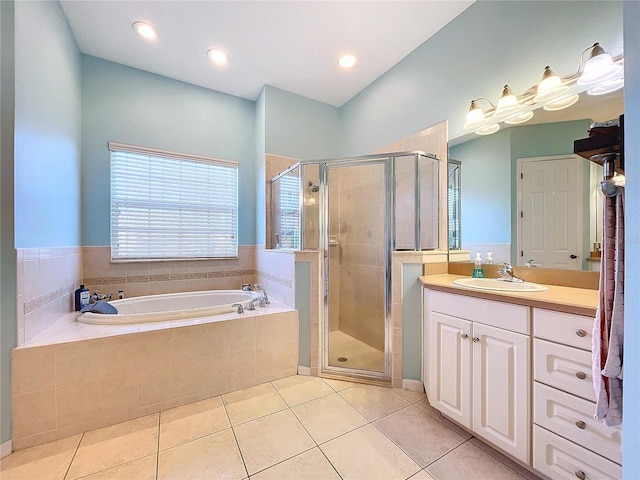 bathroom featuring tile patterned floors, shower with separate bathtub, and vanity