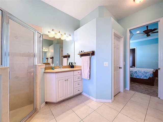 bathroom with vanity, a shower with shower door, and tile patterned flooring