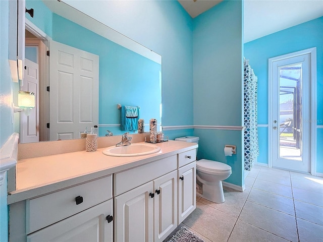 bathroom featuring tile patterned floors, toilet, and vanity