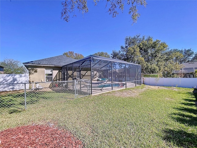 view of yard featuring a fenced in pool and a lanai