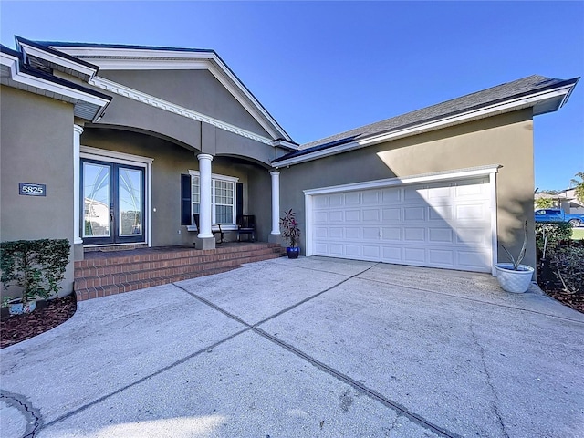 single story home with a garage and a porch