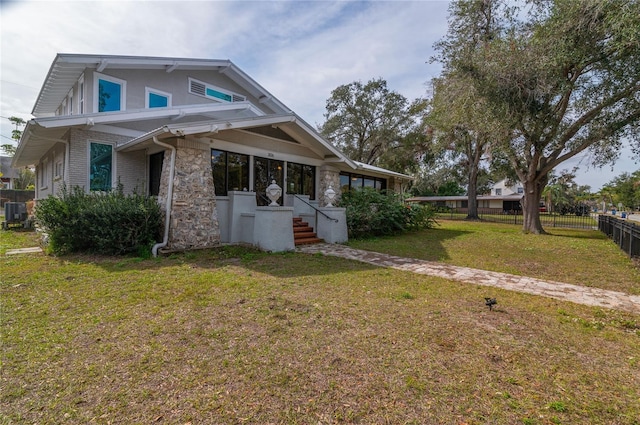 view of side of home with a yard