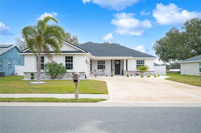 view of front of house with a front yard and central air condition unit