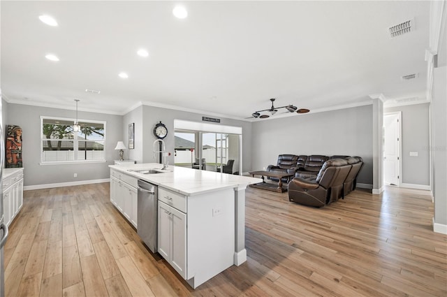 kitchen featuring sink, white cabinetry, a kitchen island with sink, plenty of natural light, and stainless steel dishwasher