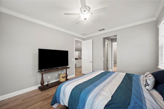 bedroom with hardwood / wood-style flooring, ornamental molding, and ceiling fan