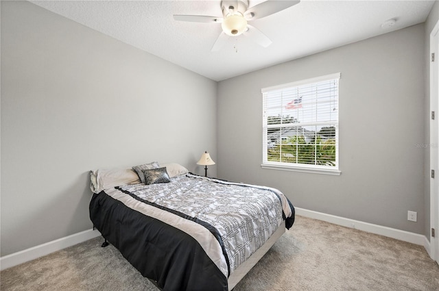 bedroom featuring light carpet and ceiling fan