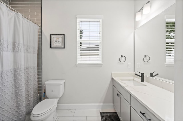 bathroom with a healthy amount of sunlight, vanity, and toilet