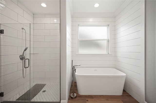 bathroom with hardwood / wood-style flooring and separate shower and tub