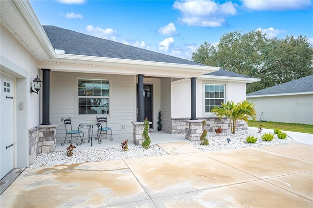 view of exterior entry with covered porch