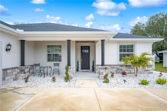 doorway to property featuring covered porch