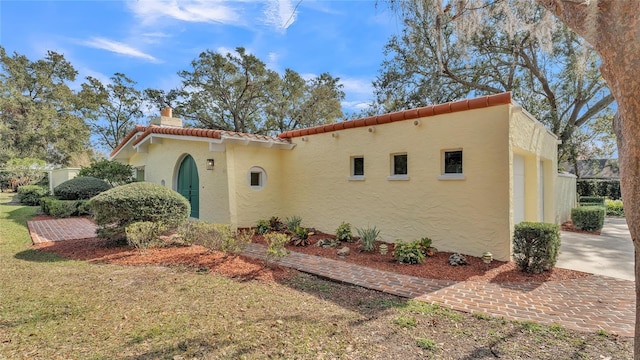 mediterranean / spanish-style house with a front lawn