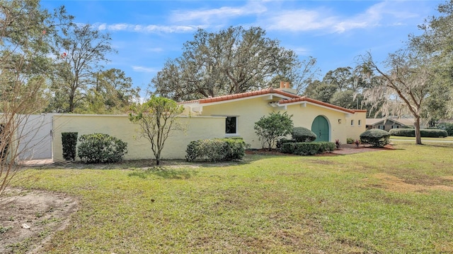 view of side of property with a lawn