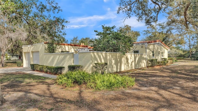 view of side of property with a garage