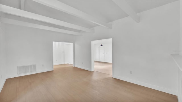 empty room with beam ceiling and hardwood / wood-style flooring