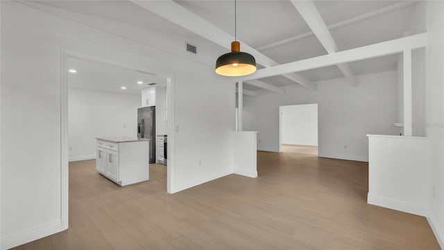 unfurnished living room with beam ceiling and light hardwood / wood-style flooring