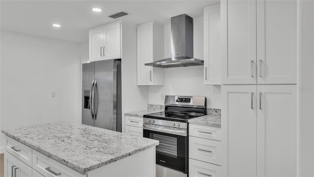 kitchen featuring white cabinets, a center island, stainless steel appliances, light stone countertops, and wall chimney exhaust hood