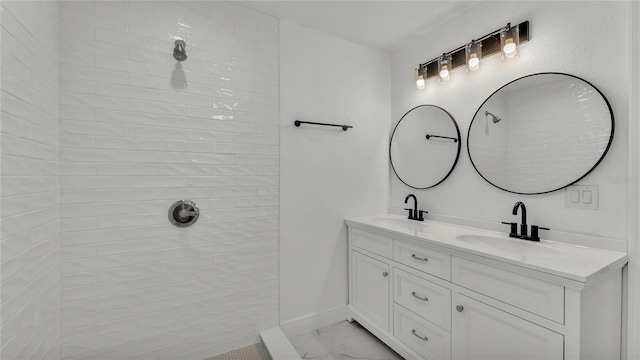 bathroom with vanity and a shower