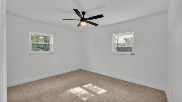 unfurnished room featuring light carpet and ceiling fan