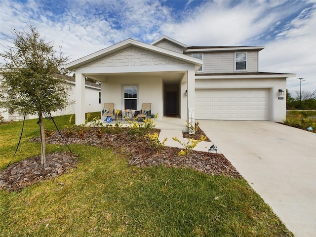 view of front of property with concrete driveway, a front lawn, an attached garage, and stucco siding