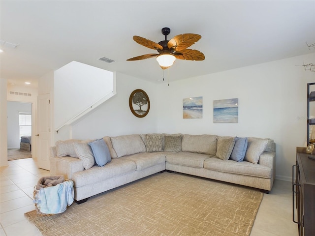 tiled living room featuring ceiling fan