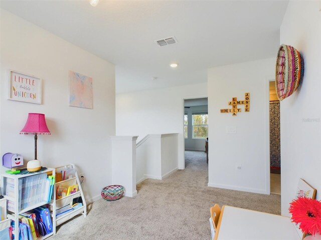 recreation room with baseboards, recessed lighting, visible vents, and light colored carpet