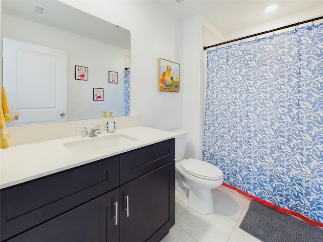 bathroom with vanity, tile patterned floors, and toilet