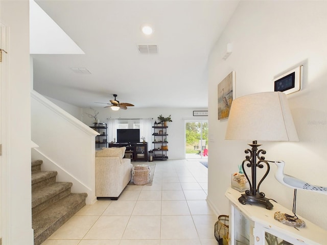 living room with light tile patterned floors and ceiling fan