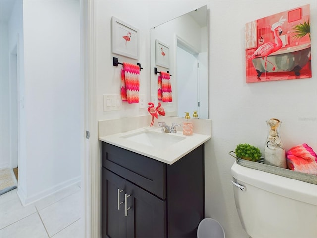 bathroom featuring tile patterned flooring, vanity, and toilet