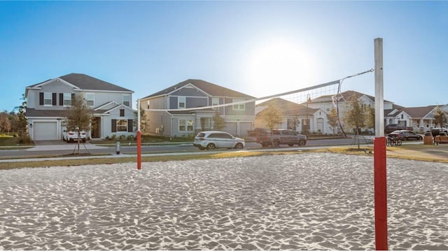 view of front facade with a residential view and volleyball court