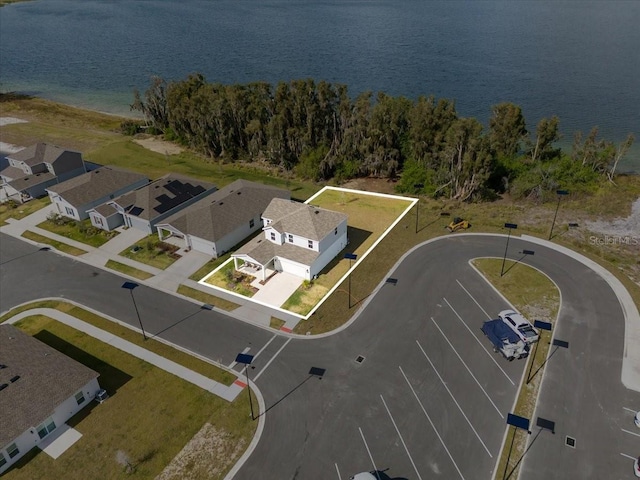 birds eye view of property featuring a residential view and a water view