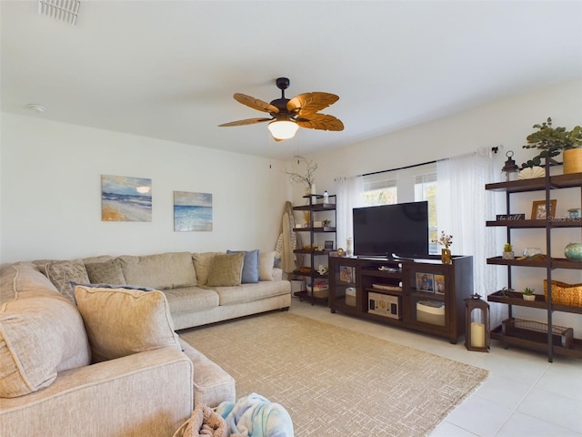 living area featuring light tile patterned floors, ceiling fan, and visible vents