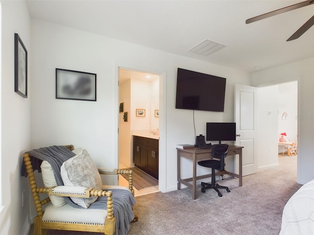 office featuring ceiling fan, visible vents, and light colored carpet