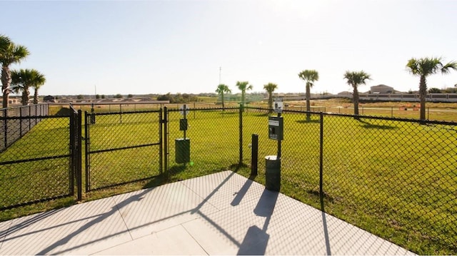 view of patio / terrace featuring a rural view, fence, and a gate