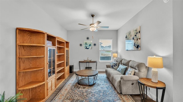 living room with ceiling fan and dark hardwood / wood-style flooring