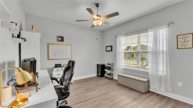 home office featuring ceiling fan and light hardwood / wood-style flooring