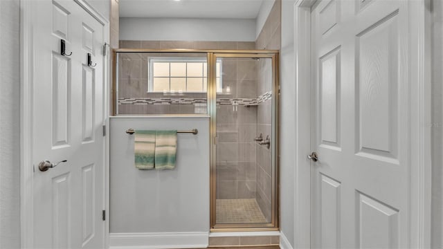 bathroom with a shower with shower door