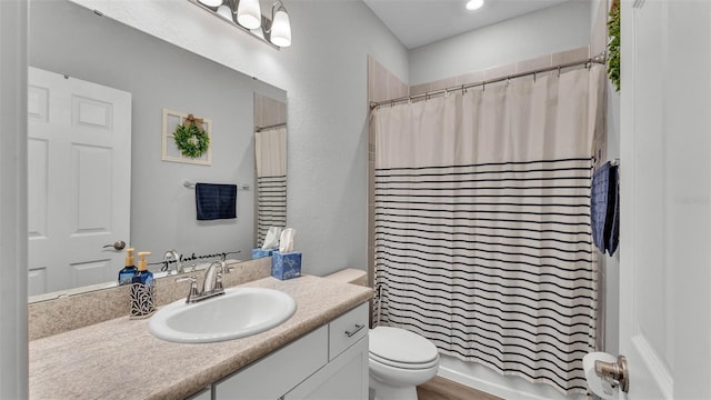 bathroom featuring vanity, toilet, and a shower with shower curtain