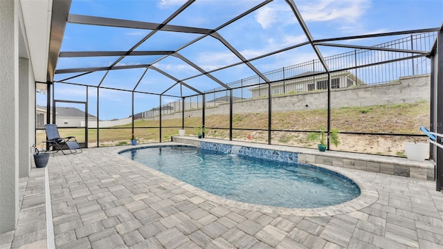 view of swimming pool with a lanai and a patio area