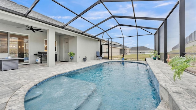 view of pool featuring pool water feature, a patio area, ceiling fan, and a lanai