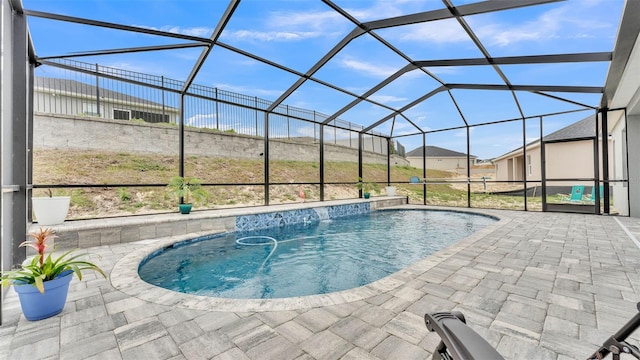 view of swimming pool with a lanai and a patio area