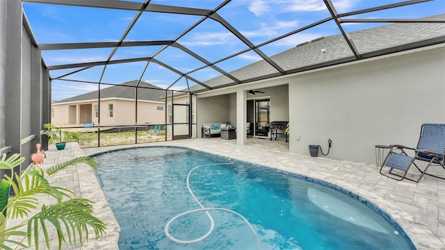 view of swimming pool featuring a patio, a lanai, and ceiling fan