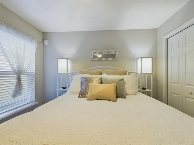 bedroom with a closet and multiple windows