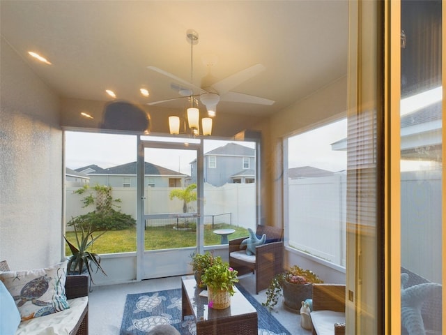 sunroom / solarium with a chandelier