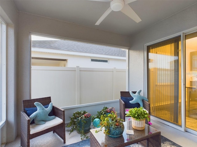 sunroom / solarium with a wealth of natural light and ceiling fan