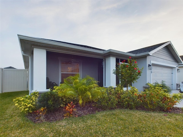 view of front of property with a garage and a front yard