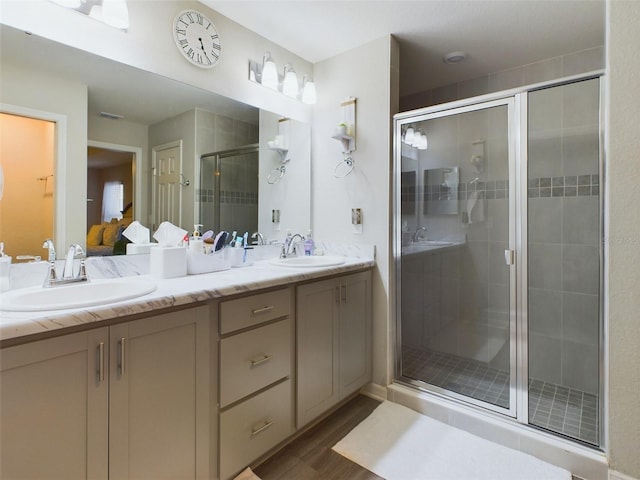 bathroom featuring vanity, a shower with door, and wood-type flooring