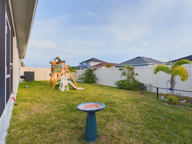 view of yard featuring a playground and central air condition unit