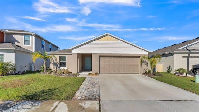 view of front of home with a garage and a front lawn