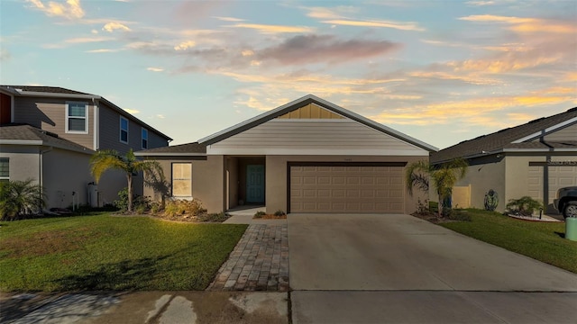 view of front facade featuring a garage and a lawn