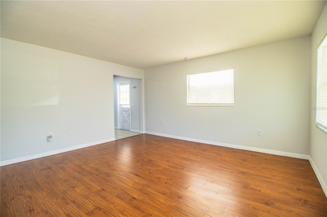 empty room featuring hardwood / wood-style flooring and plenty of natural light